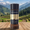DAVIDOFF coffee jar on a wooden surface with a mountainous landscape in the background