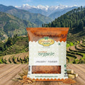 Dhampur Green jaggery powder package with a mountainous landscape in the background