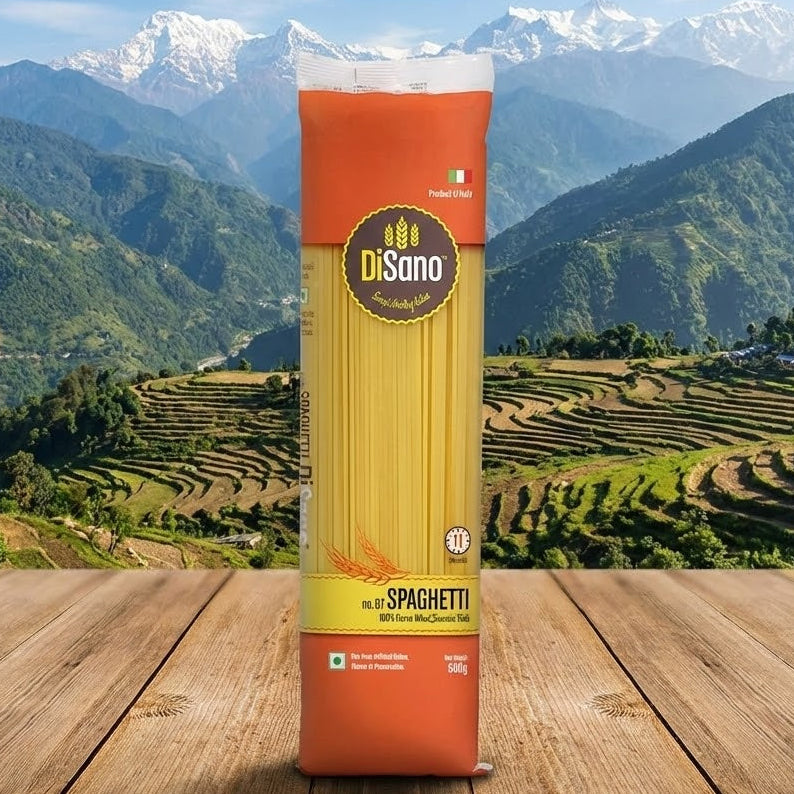 disano Spaghetti package on a wooden surface with a mountainous landscape in the background