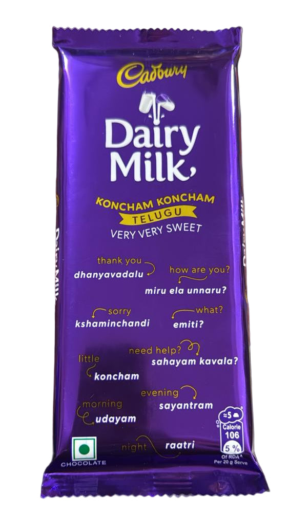 Cadbury Dairy Milk chocolate bar held by a person with a blurred background