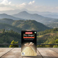 Box of Everest Dry Ginger on a wooden table with a scenic view of mountains in the background