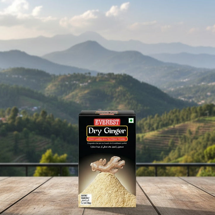 Box of Everest Dry Ginger on a wooden table with a scenic view of mountains in the background