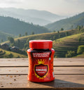 Jar of Everest Hingraj Powder on a wooden surface with a scenic mountain background