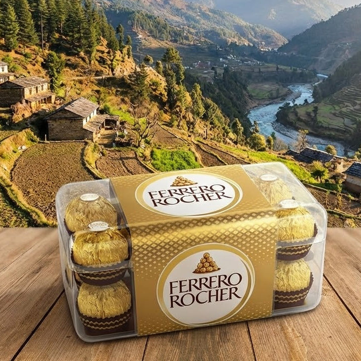 Ferrero Rocher chocolate packaging on a wooden surface with a scenic mountain landscape in the background