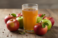 fresh apple juice in Glass with raw apple around it 
