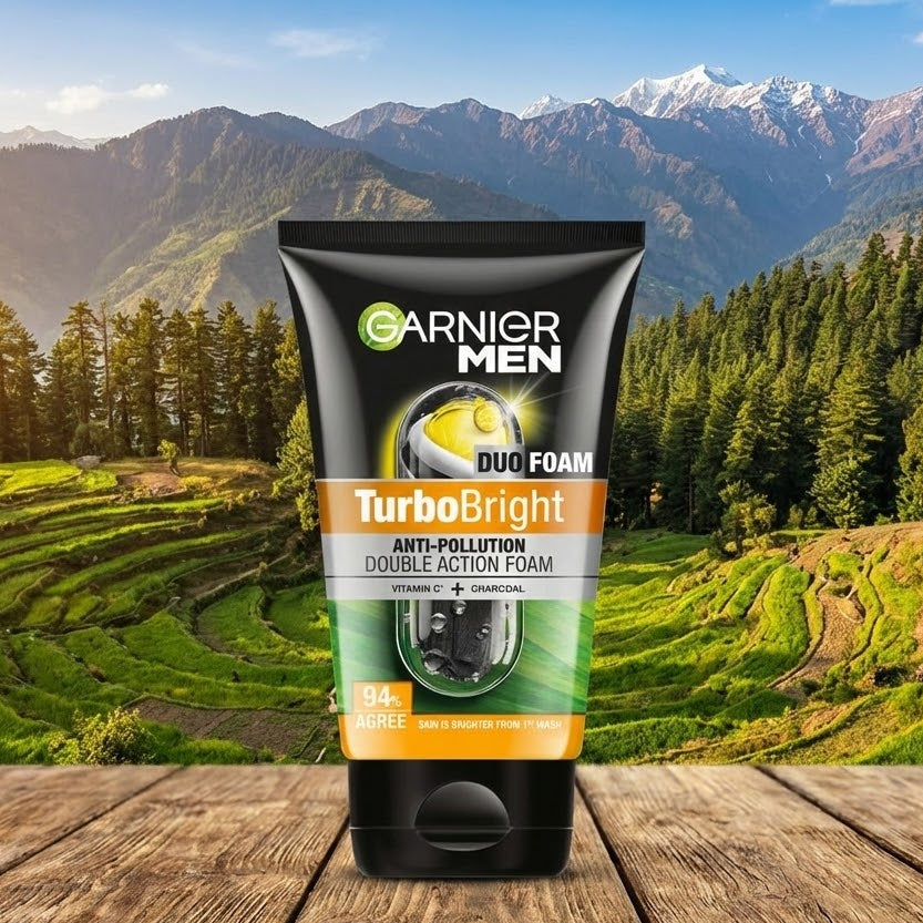 Garnier Men TurboBright foam tube on a wooden surface with a scenic mountain background