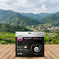 Godrej Expert Rich Creme hair colour pack on a wooden surface with a scenic mountain view in the background