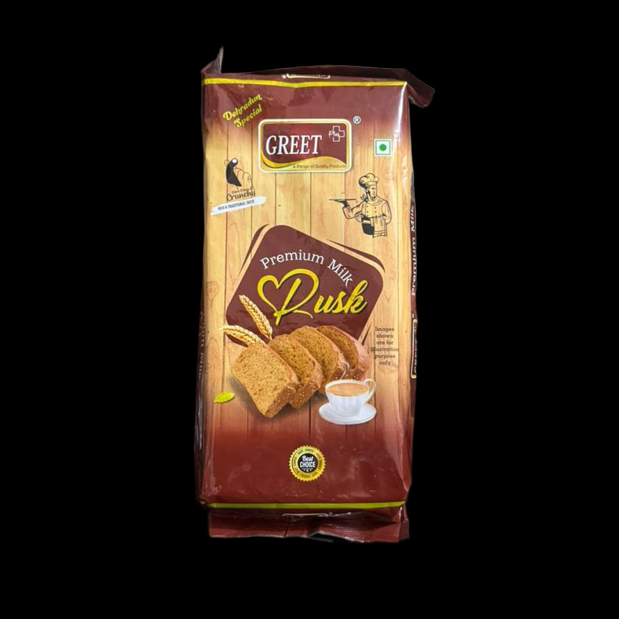 Greet Premium Mix Dussh packet held by a person in a cluttered indoor setting