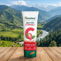Himalaya Strawberry Face Wash tube with a scenic mountain backdrop