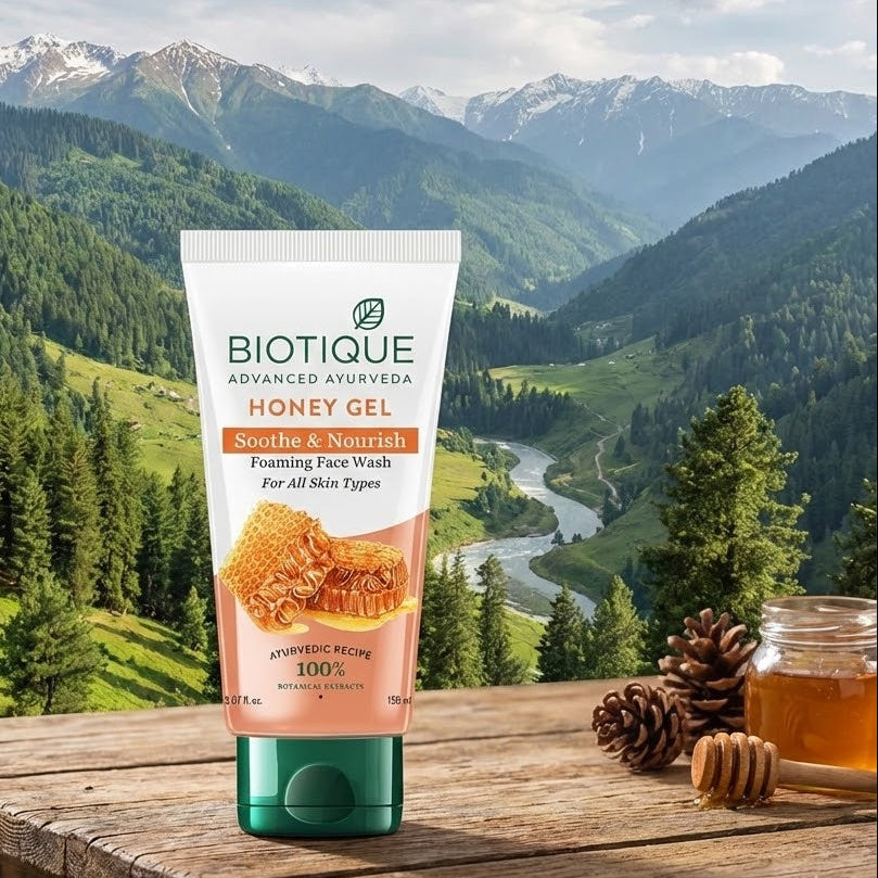 Biotique Honey Gel packaging on a wooden table with a mountainous landscape in the background