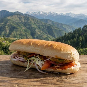 Sandwich on a wooden surface with a mountainous landscape in the background