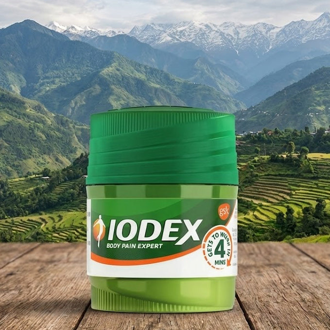 IODEX container on a wooden surface with a mountainous landscape in the background