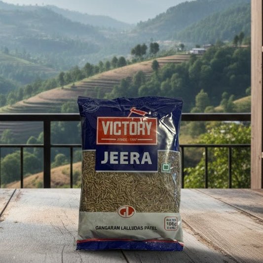Bag of Victory Jeera on a wooden table with a scenic view of mountains through large windows.