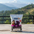 Package of chukas black pepper with a scenic mountain view in the background