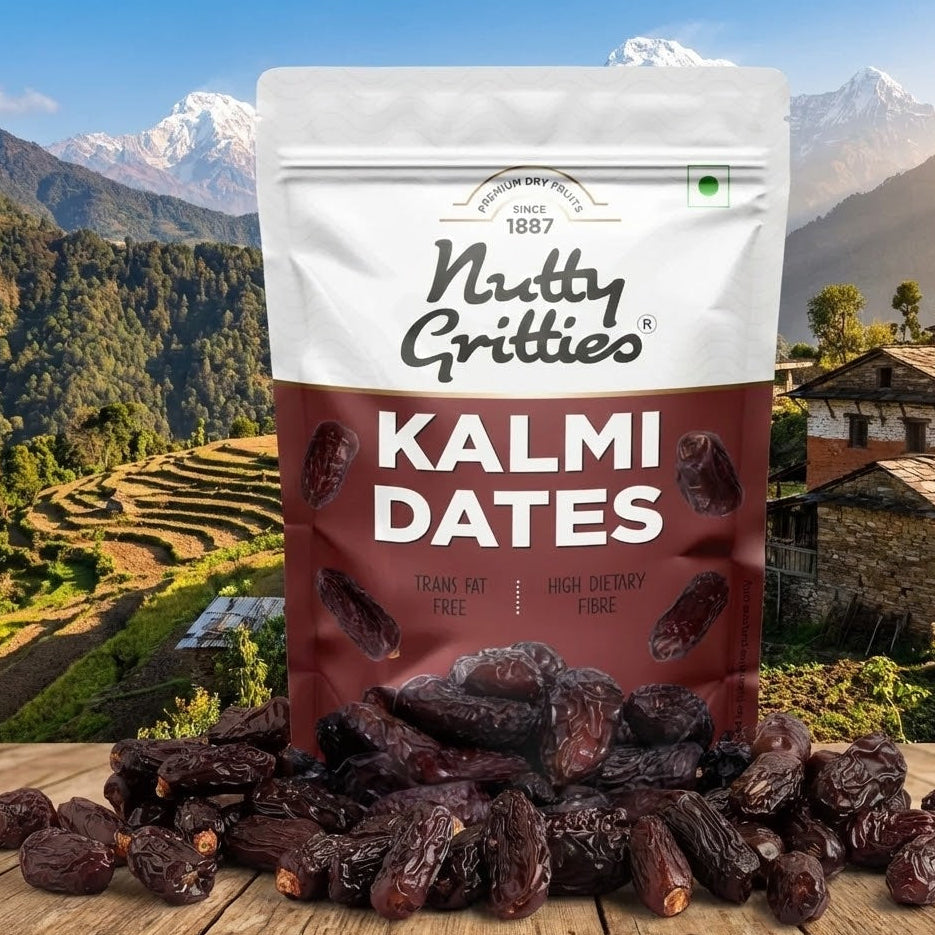 Bag of Nutty Gritties Kalmi Dates with a scenic background of mountains and terraced fields.