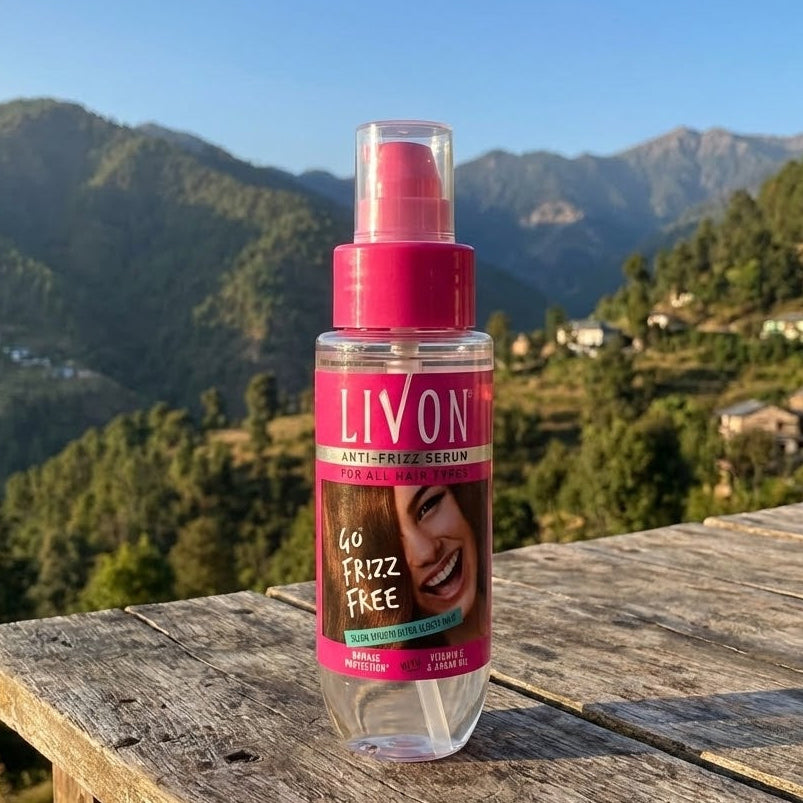 LIVON hair serum bottle on a wooden table with a mountainous landscape in the background