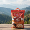 Bag of Chakki Fresh Atta with a scenic mountain background