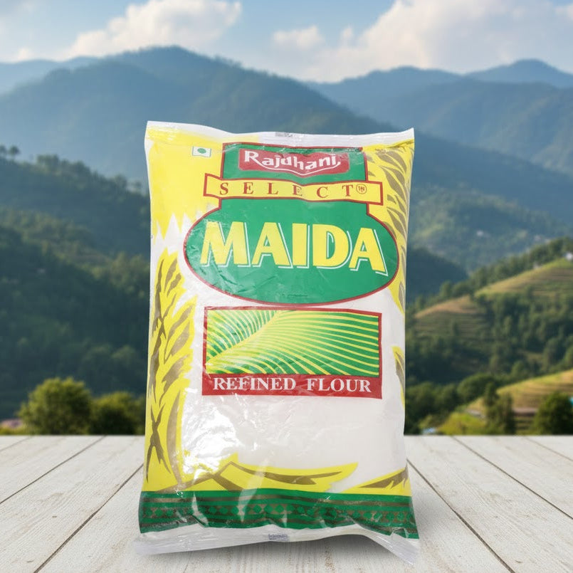 Bag of Rajdhani Select Maida refined flour on a wooden surface with a mountainous landscape in the background