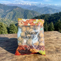 Packaged mix of nuts and seeds with mountainous landscape in the background
