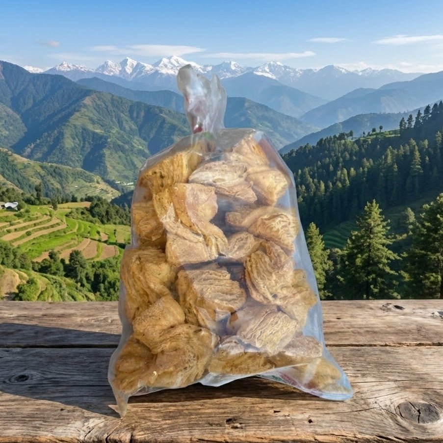 Bag of snacks on a wooden surface with a mountainous landscape in the background