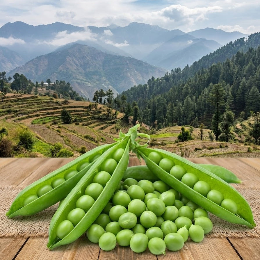 Green peas in pods on a wooden surface with a scenic mountain landscape in the background