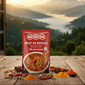 MDH Meat Ka Masala packet with spices on a wooden table with a scenic background