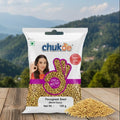 Chukde fenugreek seed package on a wooden surface with a mountainous landscape in the background