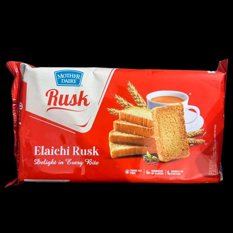 Mother Dairy Elaichi Rusk packaging held by a person with a blurred background