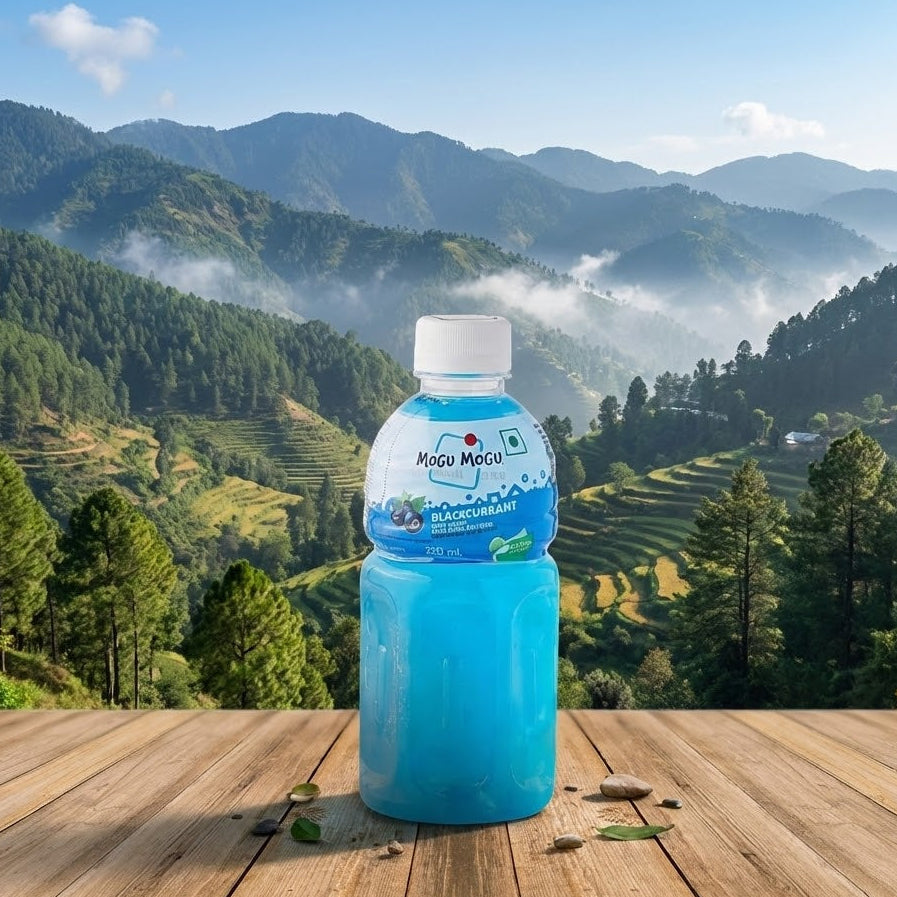 Blue bottle of Mogu Mogu on a wooden table with a scenic mountain landscape in the background