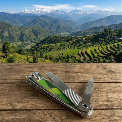 Multi-tool on a wooden surface with a scenic mountain landscape in the background