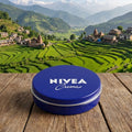 Nivea creme tin on a wooden surface with a scenic mountain landscape in the background