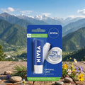 Nivea lip balm packaging with a scenic mountain background