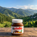 Jar of Nutella on a wooden table with a scenic mountain landscape in the background