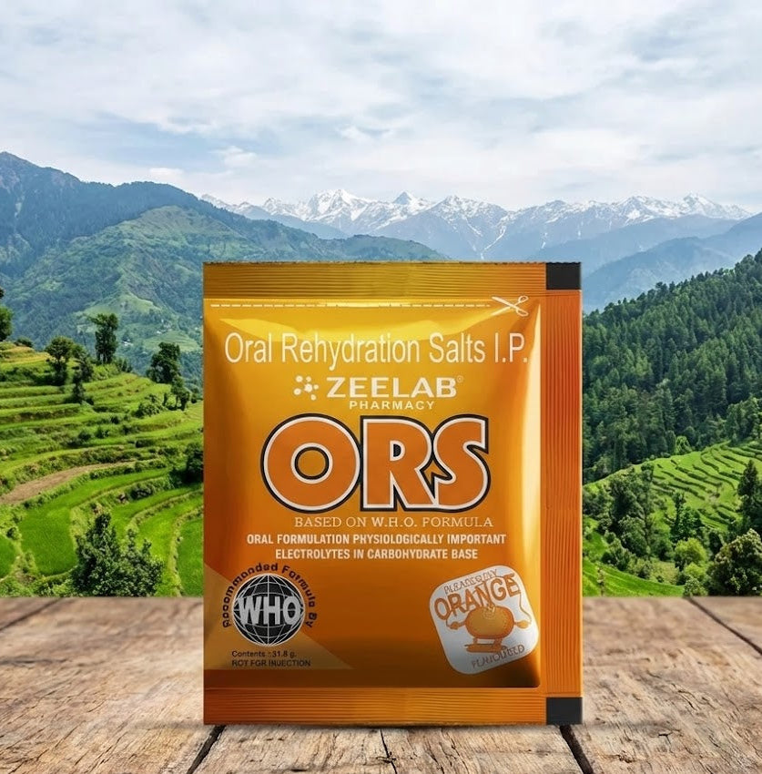 Zeelab Pharmacy ORS packet on a wooden surface with a mountainous landscape in the background