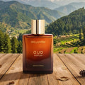 BellaVita Oud Parfum bottle on a wooden surface with a mountainous landscape in the background