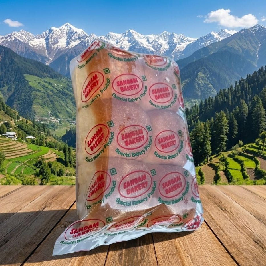 Packaged bread with 'Sangam Bakery' branding against a scenic mountain backdrop
