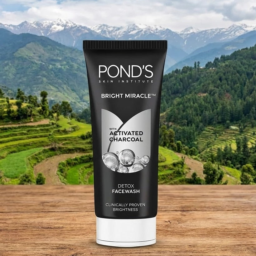 Pond's Skin Institute Bright Miracle Activated Charcoal Facewash tube with a mountainous landscape in the background