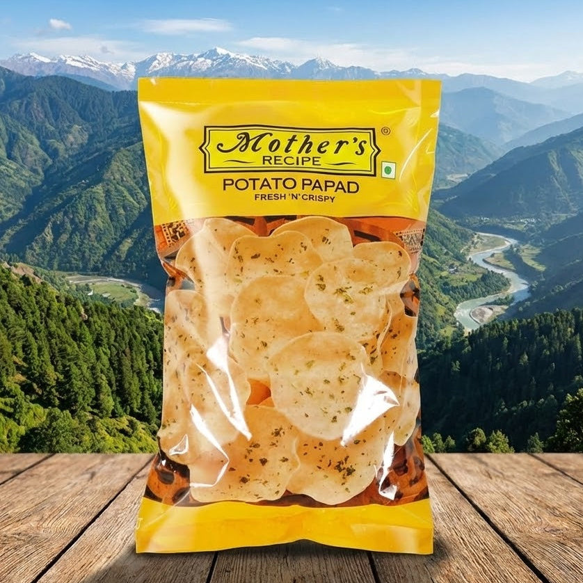 Packaged potato papad with 'Mother's Recipe' branding against a mountainous landscape.