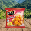 Mccain Chilli Garlic Potato Bites packet on a wooden surface with a mountainous landscape in the background