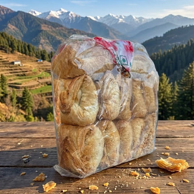 Packaged bread on a wooden surface with a mountainous landscape in the background