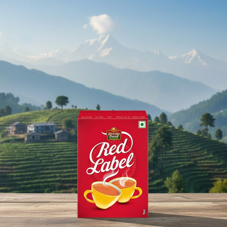 Red Label tea box on a wooden surface with a scenic mountain background