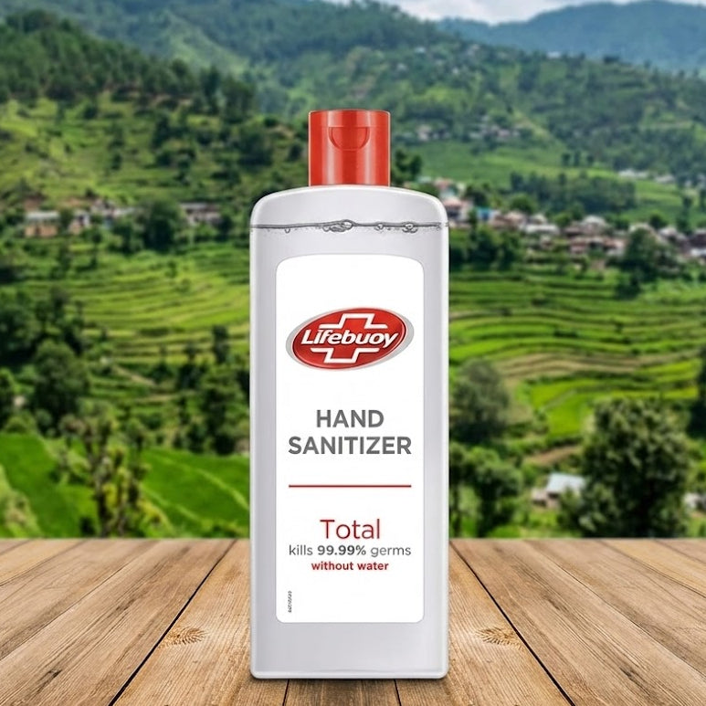 Lifebuoy hand sanitizer bottle on a wooden surface with a scenic background of green hills and houses.