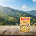 Box of Everest Shahi Biryani Masala on a wooden surface with a mountainous landscape in the background