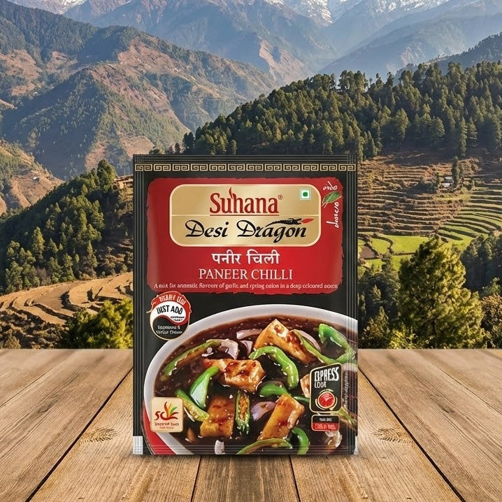 Suhana Desi Dragon Paneer Chilli package on a wooden table with a mountainous landscape in the background