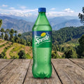 Sprite bottle on a wooden surface with a scenic mountain background