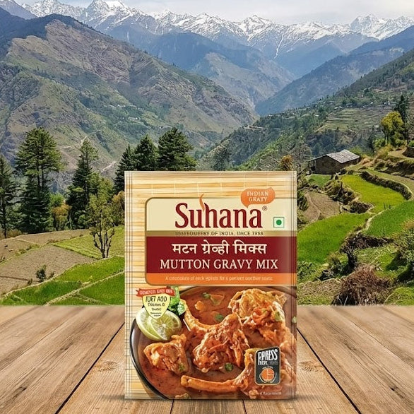 Suhana Mutton Gravy Mix package on a wooden surface with a mountainous landscape in the background