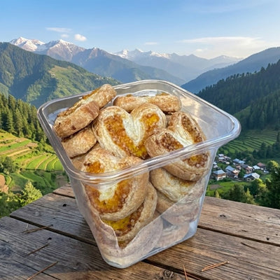 Container of pastries with a scenic mountain view in the background