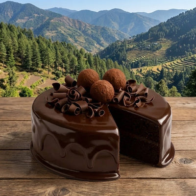 Chocolate cake with a slice taken out, set against a scenic mountain backdrop.