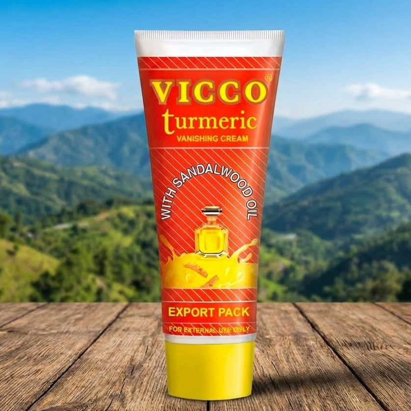 Vicco Turmeric cream tube with a mountainous landscape in the background