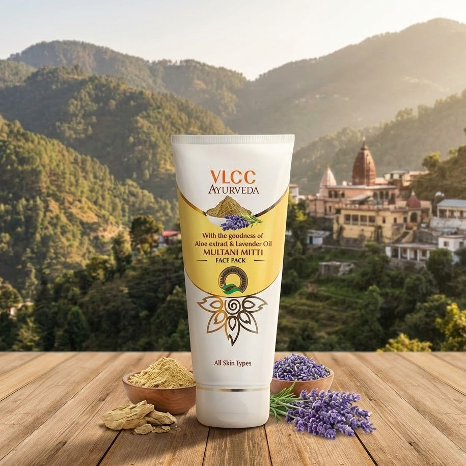 VLCC Ayurveda face pack tube with multani mitti on a wooden surface with a mountainous background